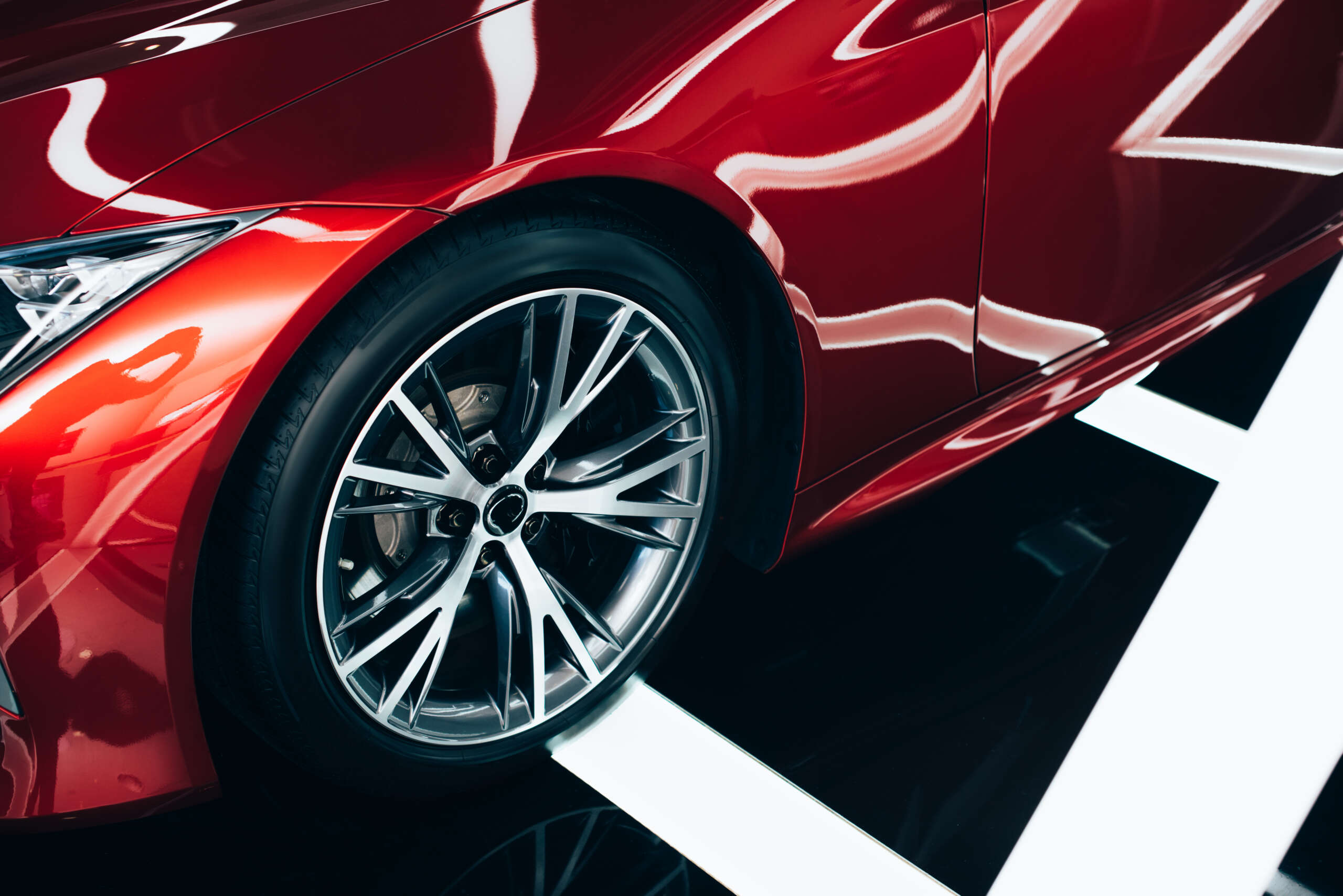 Close-Up Of A Red Car'S Front End And Headlight